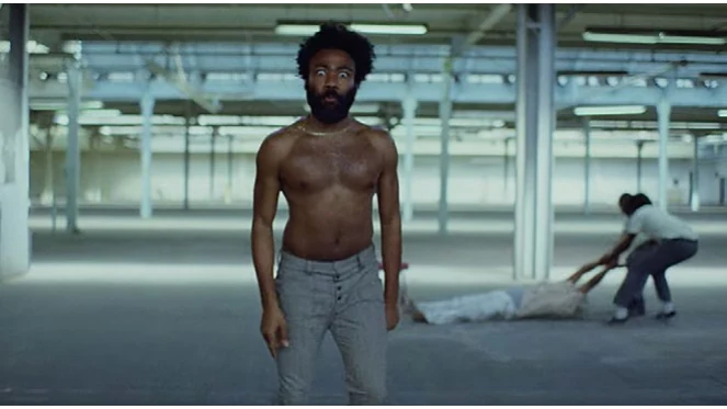 Childish Gambino standing in an empty warehouse, from the video for This Is America
